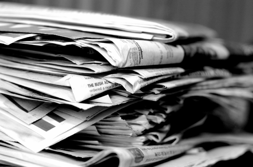 Stack of newspapers symbolizing decline of traditional bank branches in the digital age
