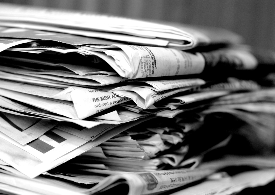 Stack of newspapers symbolizing decline of traditional bank branches in the digital age